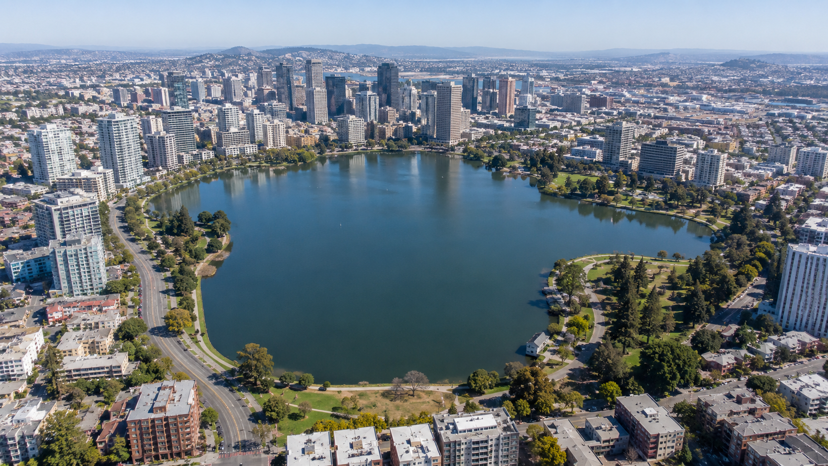 Aerial drone view of Lake Merritt, downtown Oakland, surrounding condos, parks and city skyline